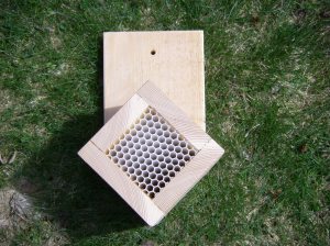 Waiting to be mounted to get morning sun, afternoon shade, one of my semi-homemade mason bee homes.  Attracting more pollinators means more garden goodies!